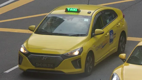 CityCab Hyundai Ioniq with the green taxi light on, showing availability