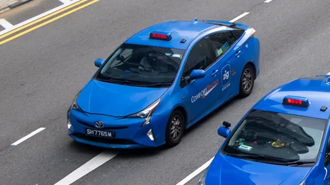 Two Comfort Taxi Toyota Prius, one HIRED and one BUSY